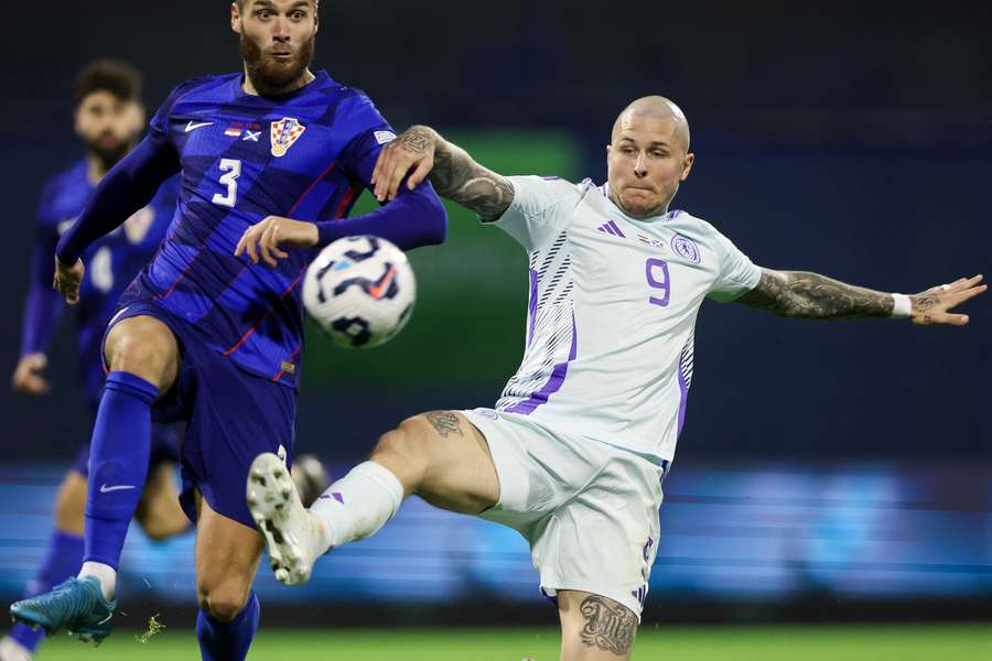 Croatia's defender Duje Caleta-Car fights for the ball with Scotland's forward Lyndon Dykes