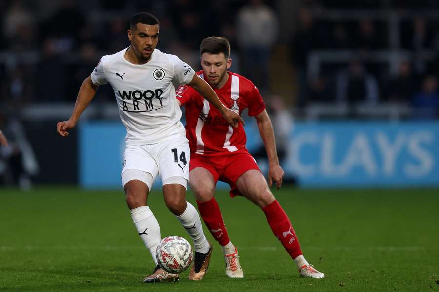 Appiah (left) in recent FA Cup action for Boreham Wood