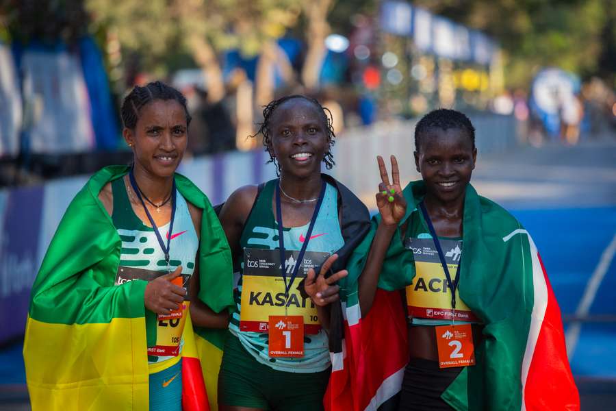 Lilian Kasait Rengeruk of Kenya is flanked by silver medallist Emmaculate Anyango Achol of Kenya and bronze medallist Lemlem Hailu of Ethiopia 