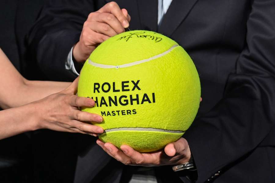 An official signs a big tennis ball during the Shanghai Masters 2023 launch ceremony 