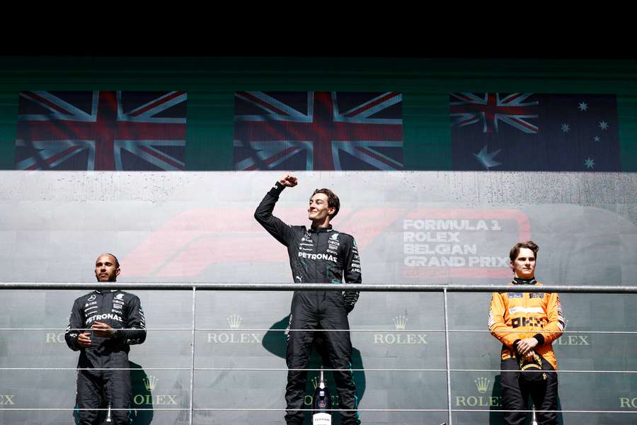 Mercedes' British driver Lewis Hamilton, Mercedes' British driver George Russell and McLaren's Australian driver Oscar Piastri on the podium