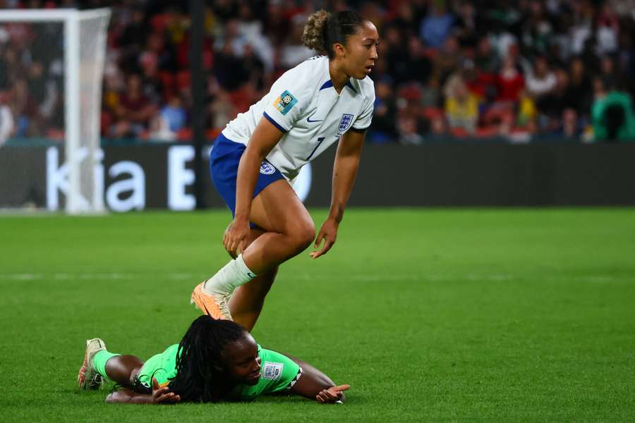 Nigeria's defender #22 Michelle Alozie (lower) reacts after being fouled by England's forward #07 Lauren James