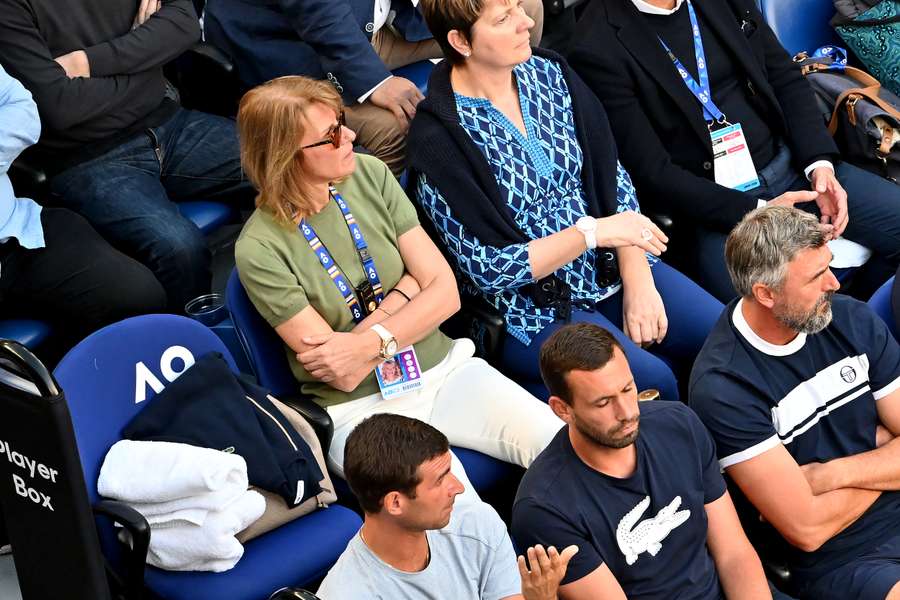 An empty seat of Novak Djokovic's father Srdjan is seen next to his mother Dijana Djokovic