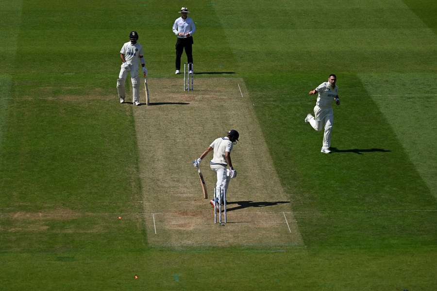 Bails fly as Australia's Scott Boland (R) celebrates taking the wicket of India's Shubman Gill for 13 runs