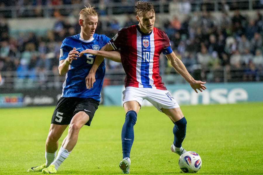 Martin Odegaard shields the ball from Estonia's Rocco Robert Shein