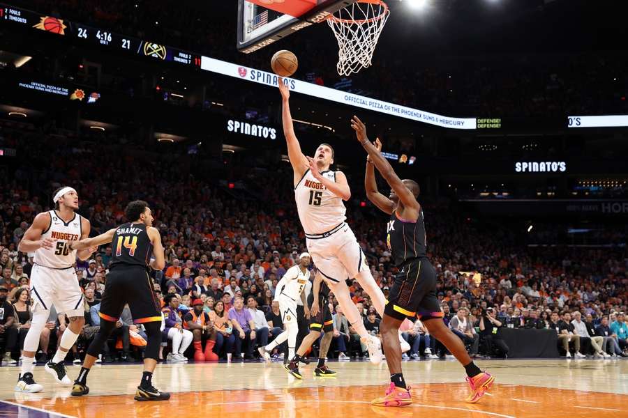 Jokic (c) in action for the Nuggets