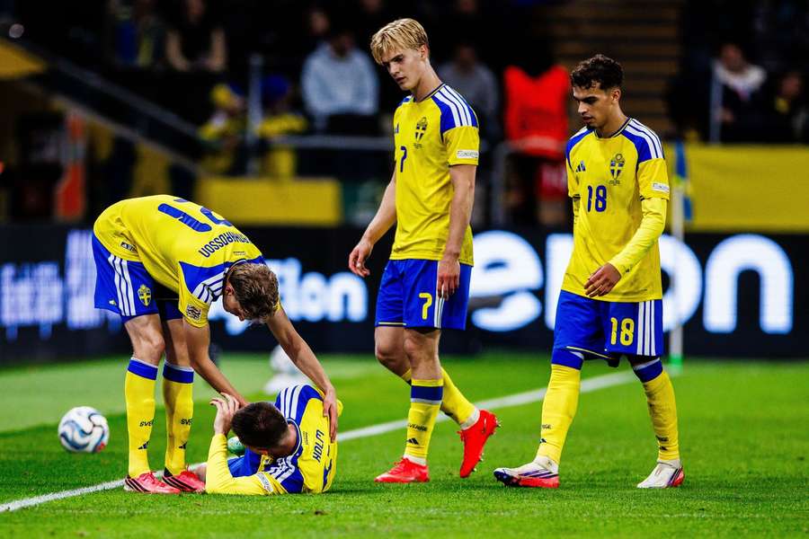 Emil Holm consoled by teammates in Sweden's win Emil Holm consoled by teammates in Sweden's win