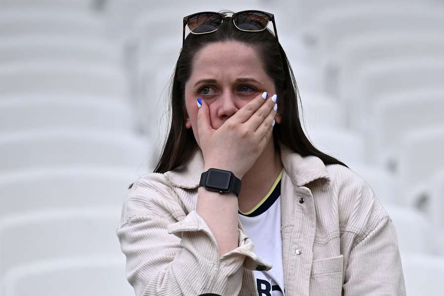 A Leeds fan reacts after the English Premier League football match between West Ham United and Leeds United at the London Stadium