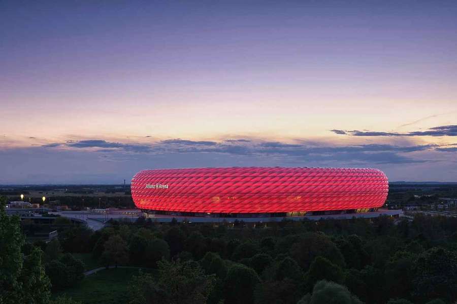 The Allianz Arena, bathed in red lighting, and pictured from above, will host this season's Champions League final.