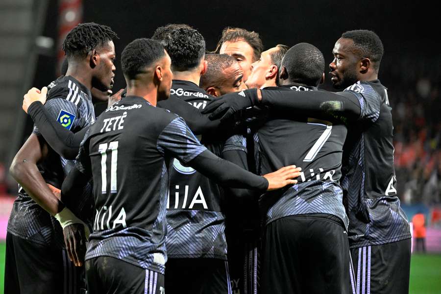 Lyon's players celebrate a goal against Brest