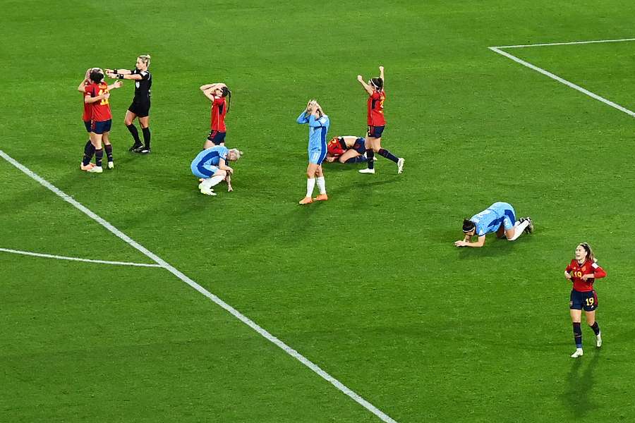 England players fall to the floor as the final whistle blows