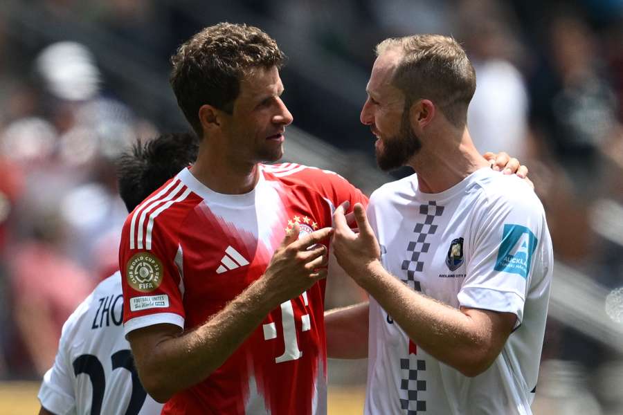 Bayern Munich's Thomas Muller and Auckland City's Michael Den Heijer embrace after their Club World Cup clash