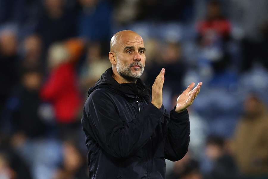 Manchester City manager Pep Guardiola applauds fans after the Huddersfield game