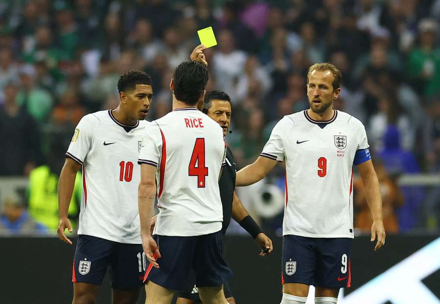 England's Declan Rice is shown a yellow card by referee