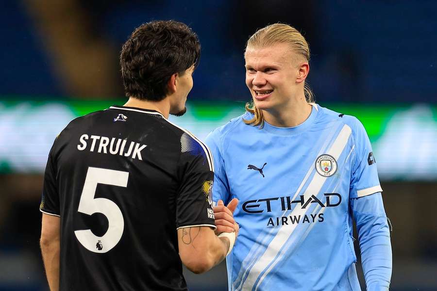 Manchester City's Erling Haaland chats with Leeds' Pascal Struijk