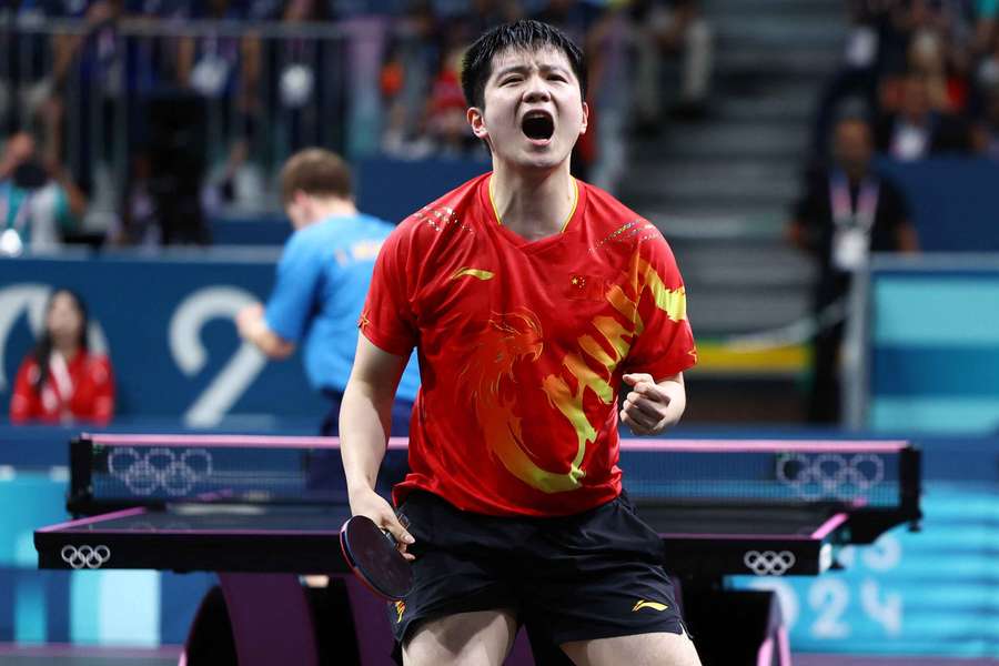 Zhendong Fan of China celebrates after winning his gold medal match against Truls Moregard of Sweden