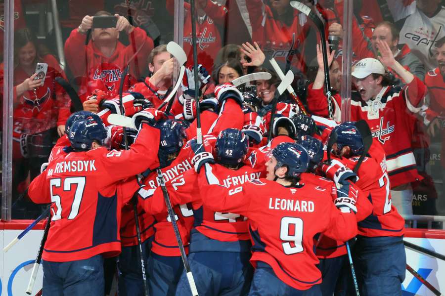 Alex Ovechkin is mobbed after scoring against the Chicago Blackhawks