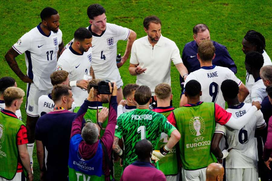 Gareth Southgate speaks to players of England prior to extra time being played