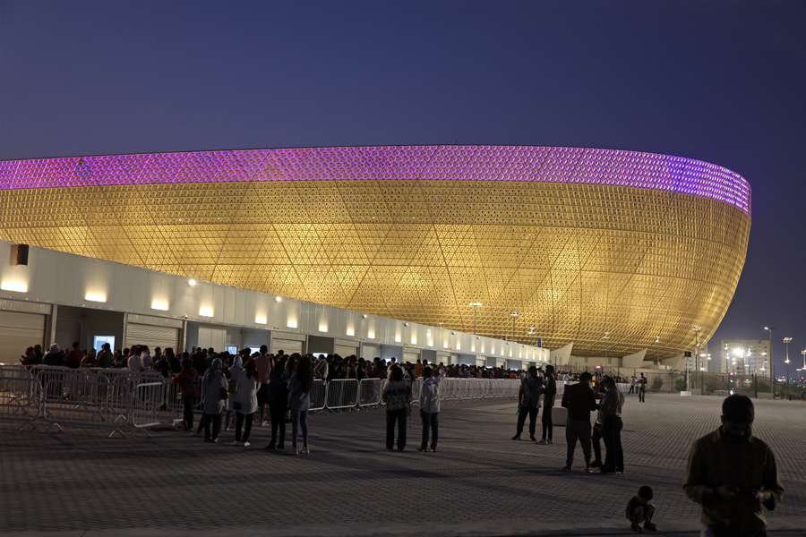 People arrive at the Lusail Stadium on the outskirts of Qatar's capital Doha