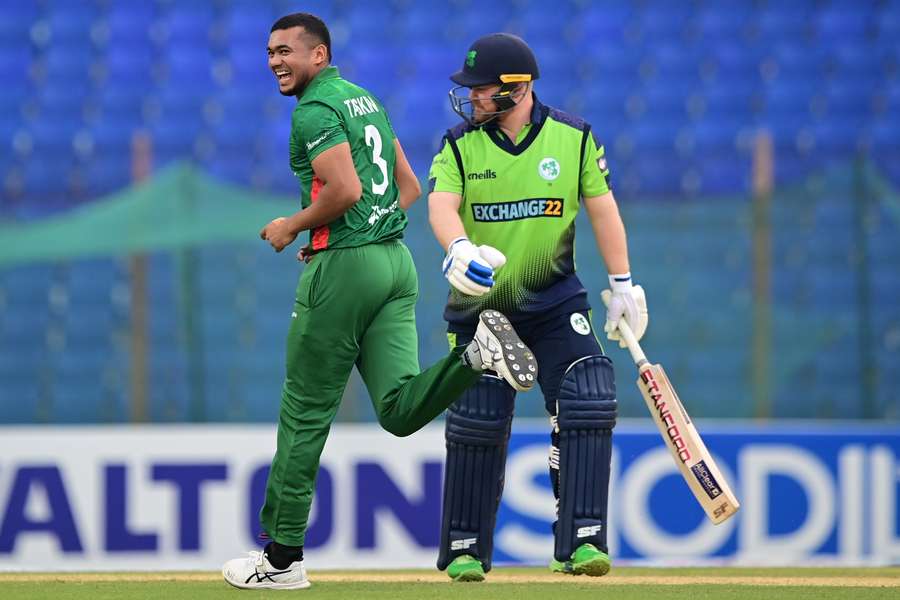 Bangladesh's Taskin Ahmed (L) reacts after the dismissal of Ireland's captain Paul Stirling (R)