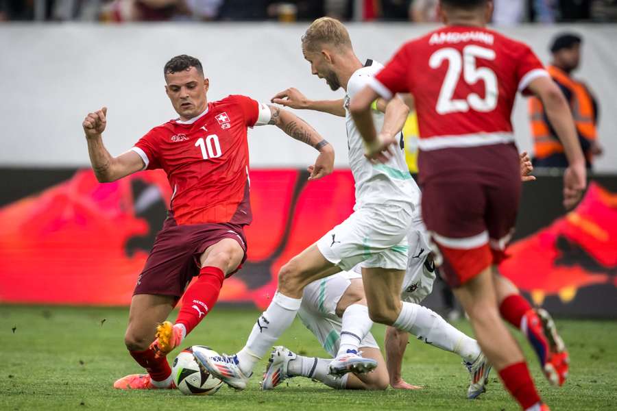 Switzerland's midfielder #10 Granit Xhaka (L) vies with Austria's midfielder #20 Konrad Laimer (C) during a friendly