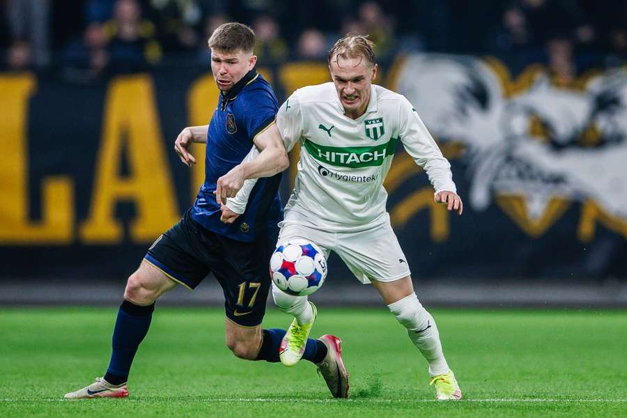 AIK's Mads Dohr Thychosen and Vasteras' Marcus Baggesen fight for possession