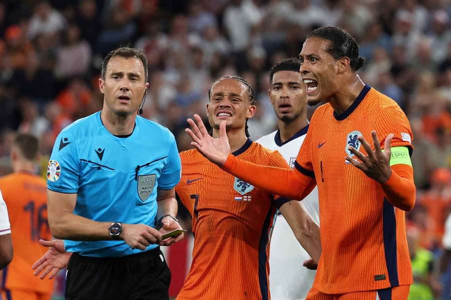 Virgil van Dijk argues with the referee during the semi-final