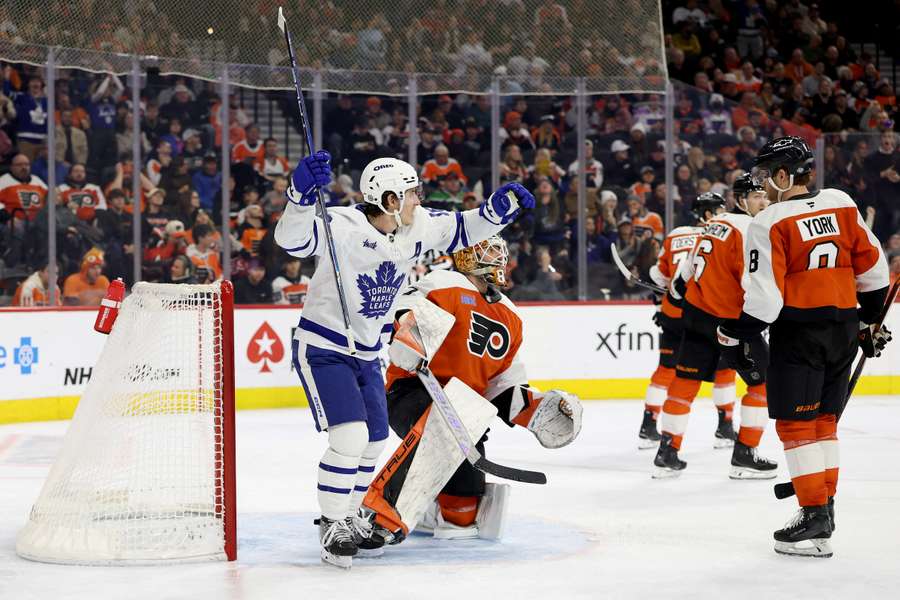 Toronto Maple Leafs Mitch Marner celebrating a goal by teammate Matthew Knies against the Flyers