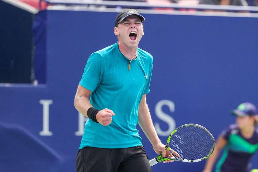 Alex Michelsen celebrates beating Lorenzo Musetti