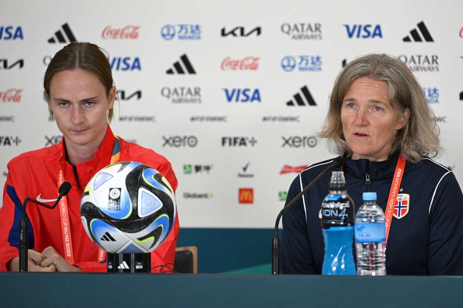 Graham Hansen sits alongside Riise in a press conference