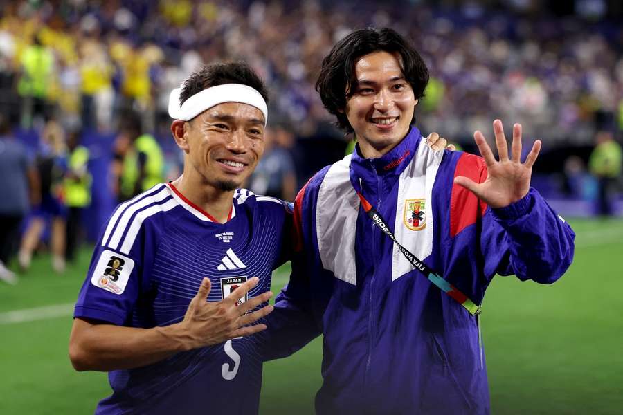 Minamino (right) alongside Yuto Nagatomo after Japan vs Sweden