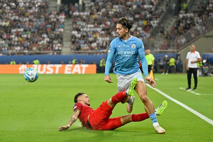Manchester City's English midfielder #10 Jack Grealish (R) and Sevilla's Argentinian forward #05 Lucas Ocampos (L) fight for the ball