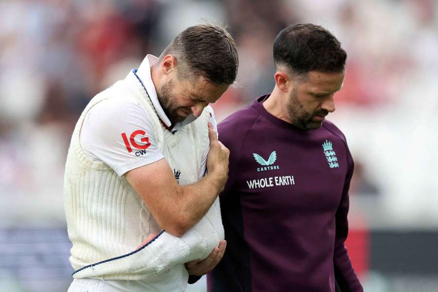 Woakes reacts after sustaining an injury