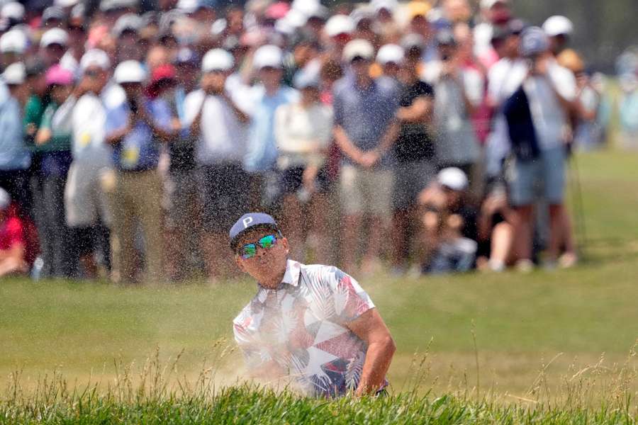 Rickie Fowler plays a shot from a bunker on the first hole during the second round of the US Open 