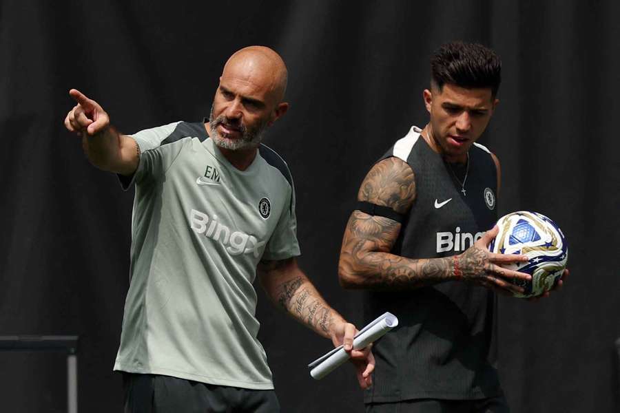Chelsea manager Enzo Maresca reacts with Enzo Fernandez during training