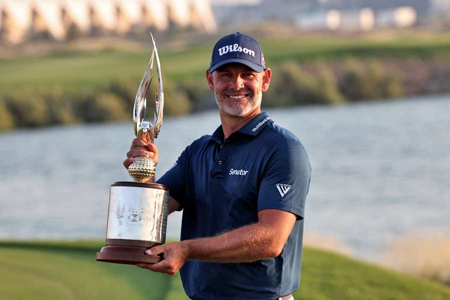 Paul Waring holds the trophy after winning the final round of the Abu Dhabi Championship