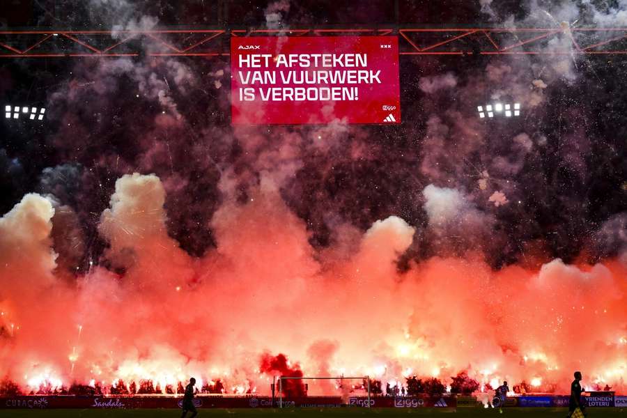 Ajax fans set off fireworks in the fifth minute of the game against FC Groningen