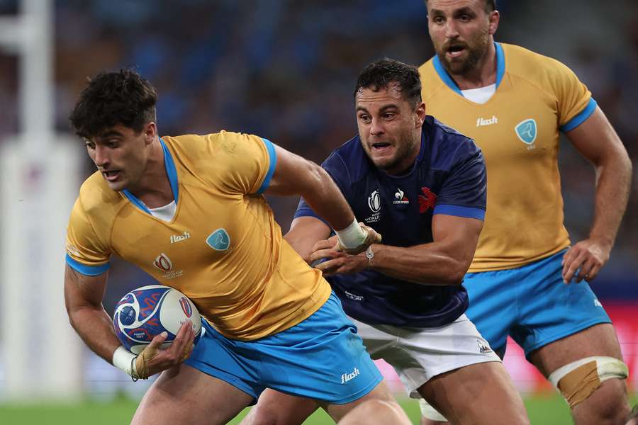 Uruguay's wing Bautista Basso (L) is tackled by France's centre Arthur Vincent