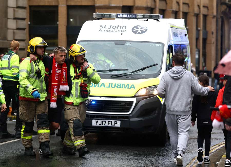 A fan is taken away by emergency services