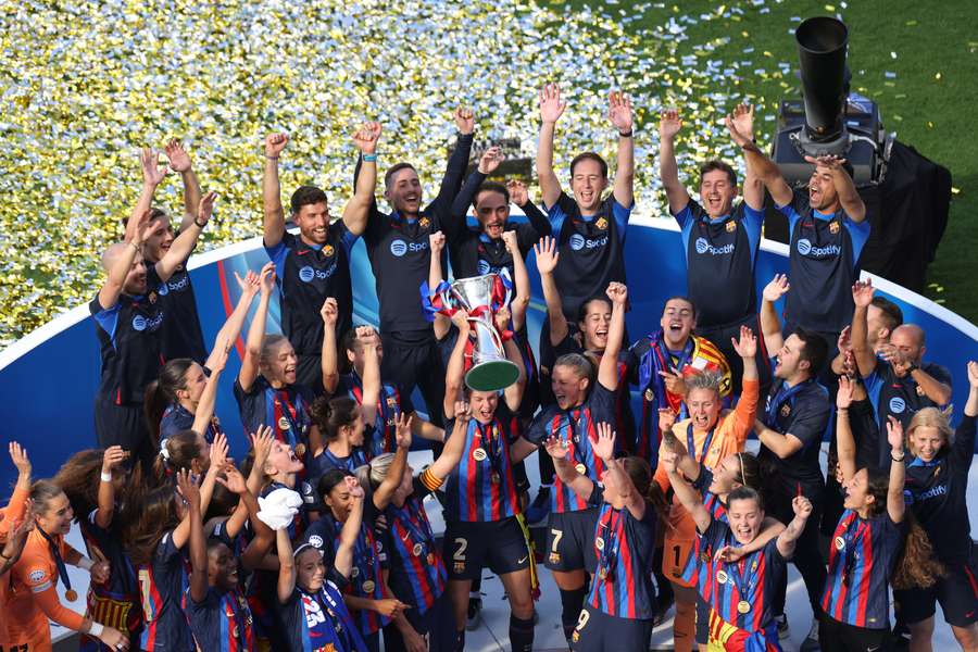 FC Barcelona team players celebrate their team's victory with the trophy on the podium after winning the UEFA Women's Champions League final