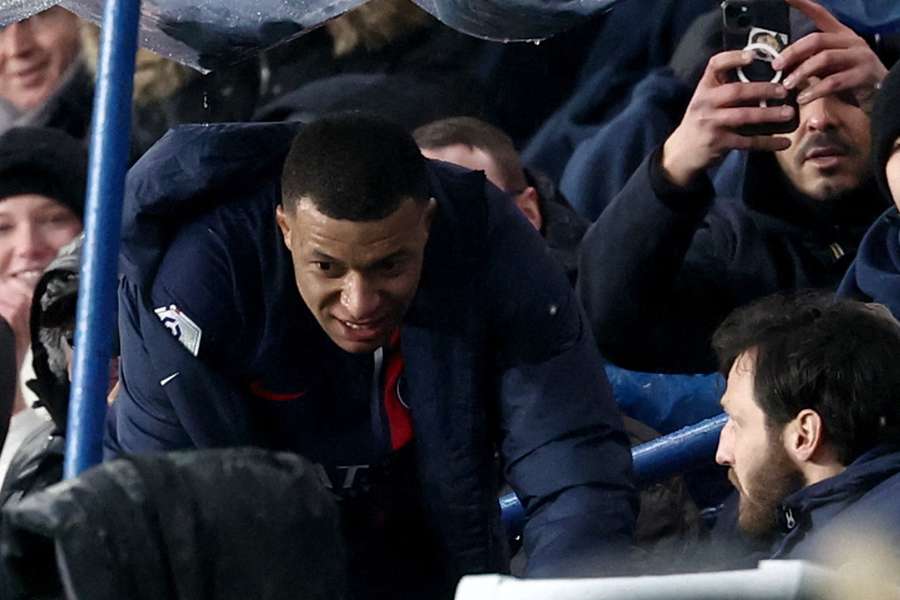 Paris Saint-Germain's French forward #07 Kylian Mbappe (L) sits after being substituted