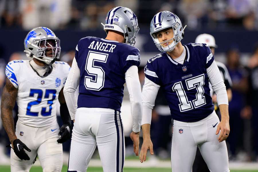 Brandon Aubrey of the Dallas Cowboys celebrates with Bryan Anger after making a field goal against the Detroit Lions