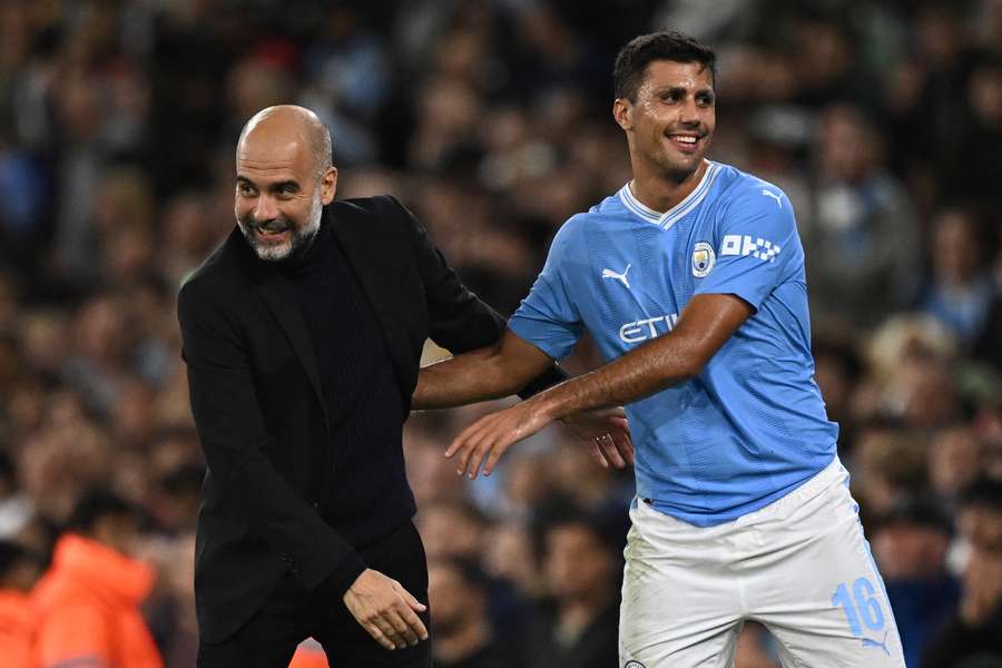 Manchester City's Spanish manager Pep Guardiola congratulates Manchester City's Spanish midfielder #16 Rodri as he leaves the pitch