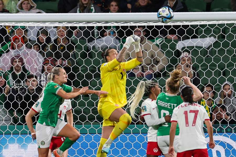 Canada's goalkeeper Kailen Sheridan (C) punches clear