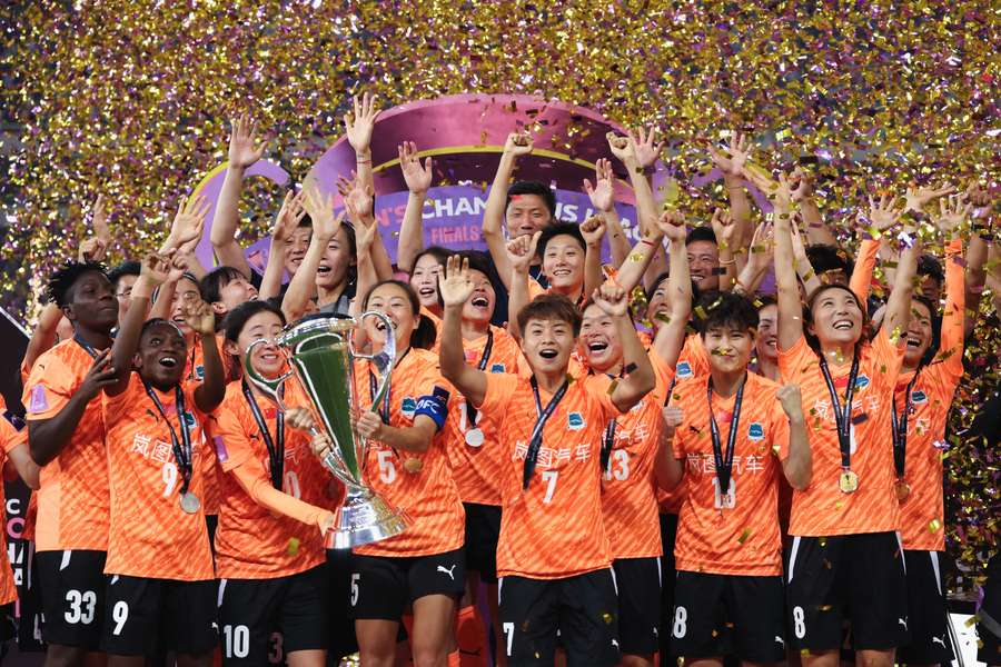 Wuhan Jiangdu lift the trophy after winning on penalties