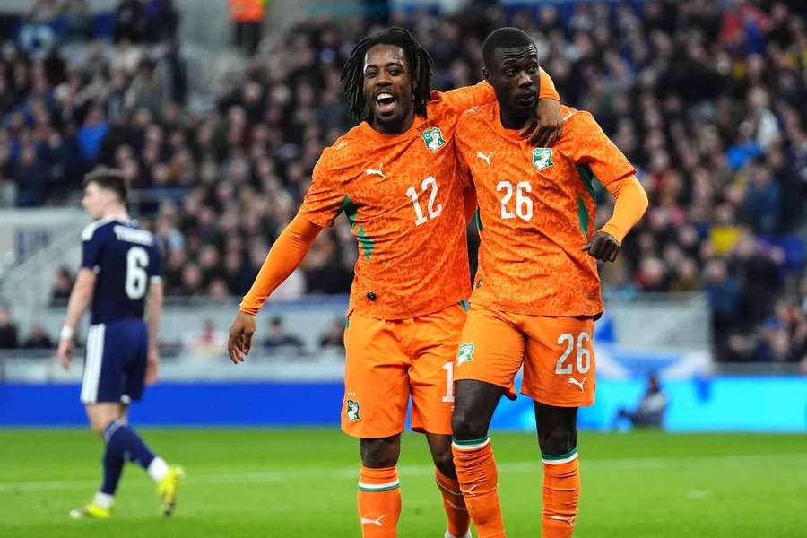 Nicolas Pepe (R) celebrates after scoring