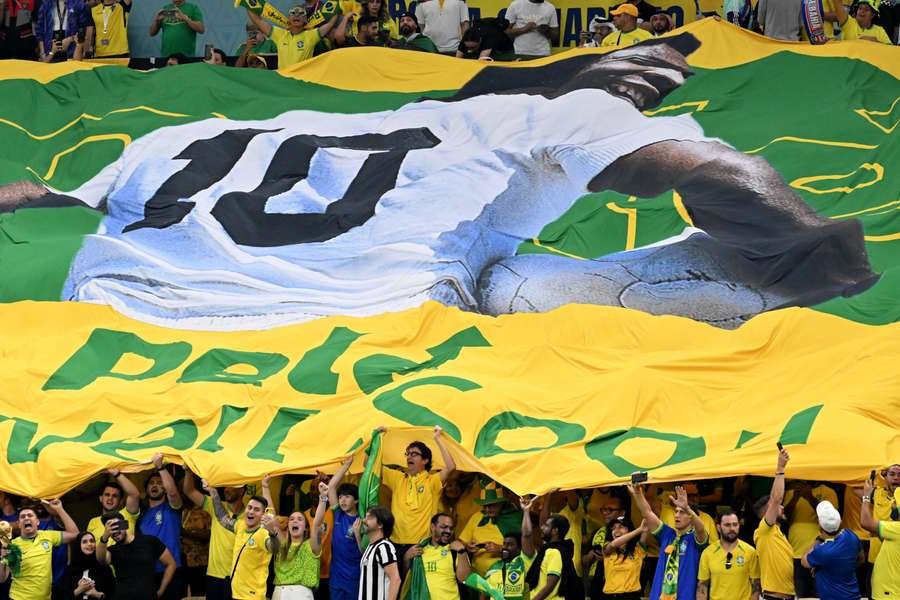 Brazil supporters held up a sign with a picture of Pele that read 'get well soon' during their match against Cameroon