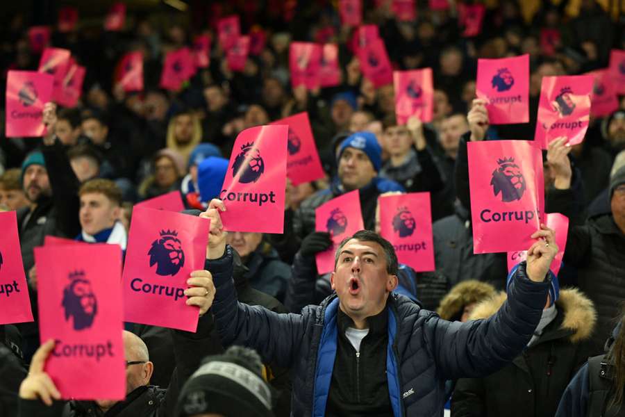 Everton fans hold protest banners aloft following the club's recent 10-point deduction