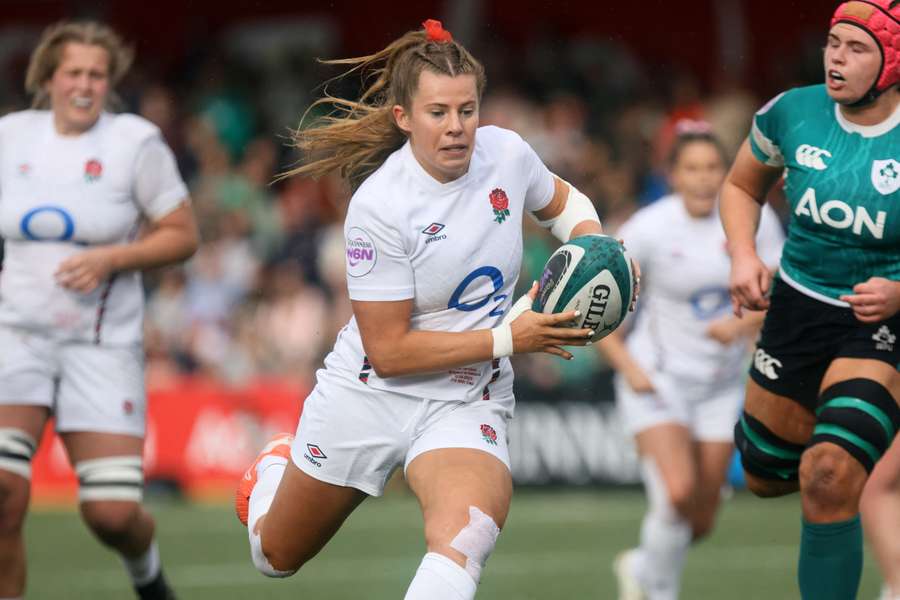 England's fly-half Zoe Harrison runs in a try