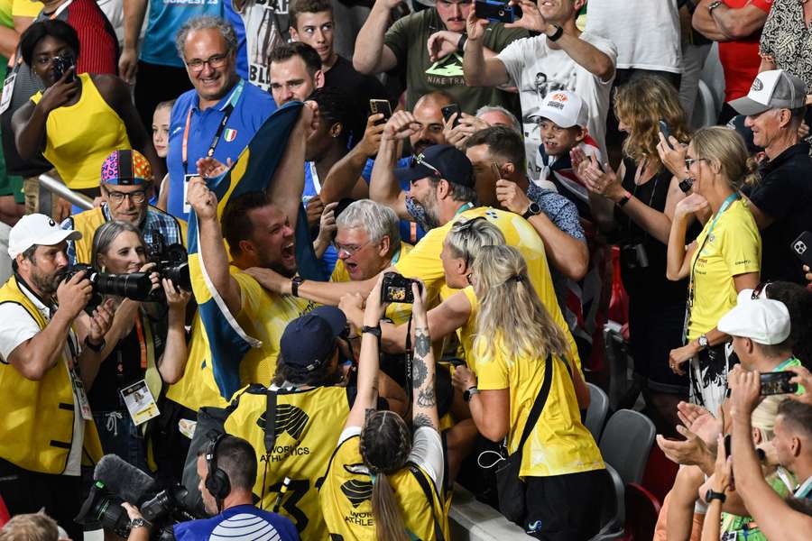 Daniel Ståhl celebrates with relatives after winning the men's discus throw final with his last throw